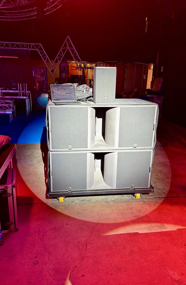 Two L-Acoustics subwoofers stacked on their cart