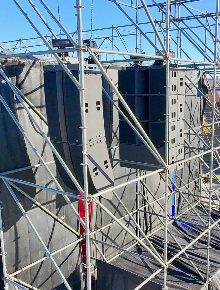 Two L2 arrays flown from an outdoor scaffolding structure